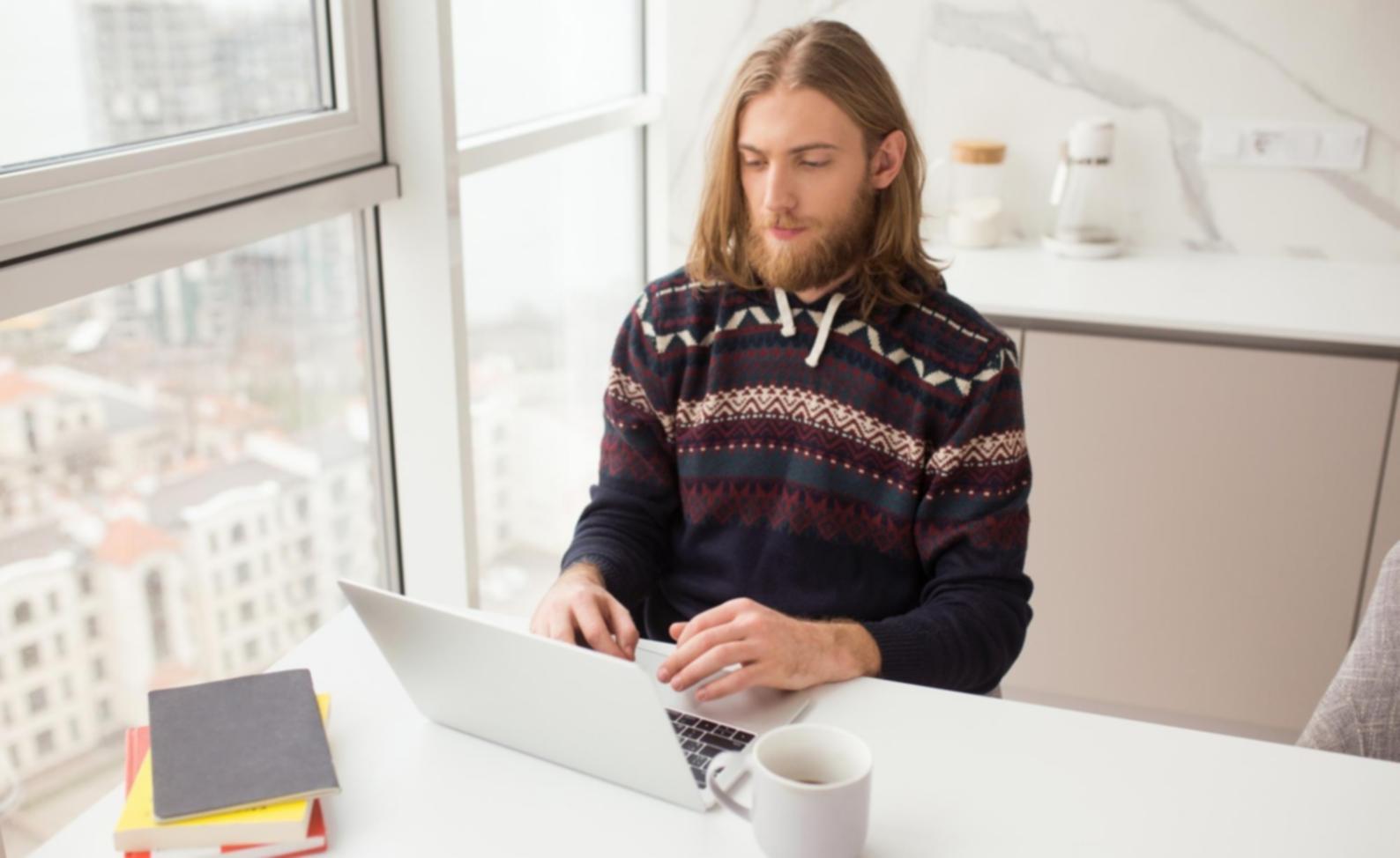 Executive reviewing positive financial reports and growth charts in a modern office setting
